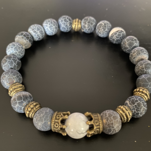 Blue & White Crackle Agate w/ Brass Crown charms holding a cream Howlite Bead